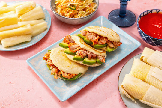 Venezuelan and Colombian arepas feast with pork and avocado