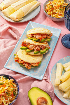 Venezuelan and Colombian arepas feast on pink background