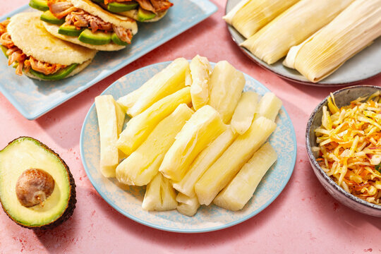 Boiled yuca with pupusa, humita and curtido festive table