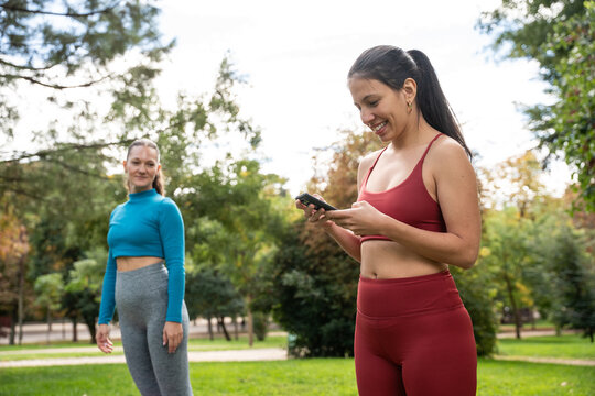 Multiethnic women using smartphone during outdoor workout