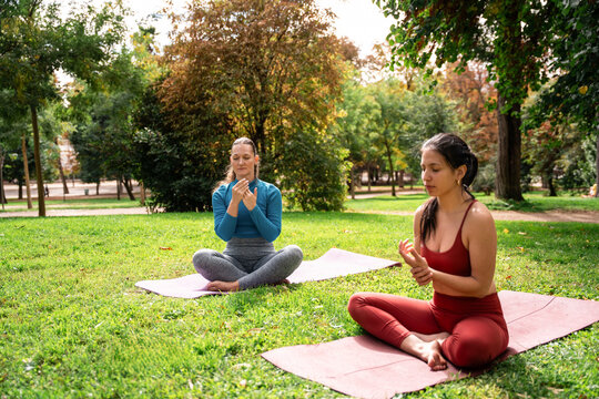 Multiethnic women practicing self massage on yoga mats
