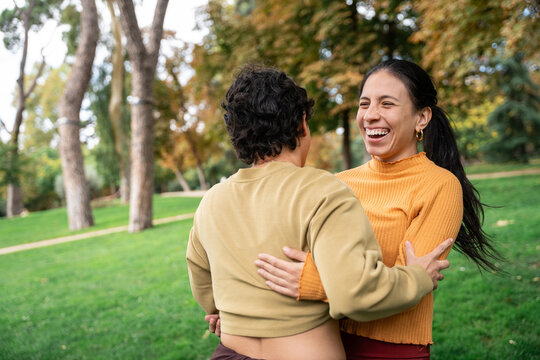 Joyful embrace in park during spiritual retreat weekend