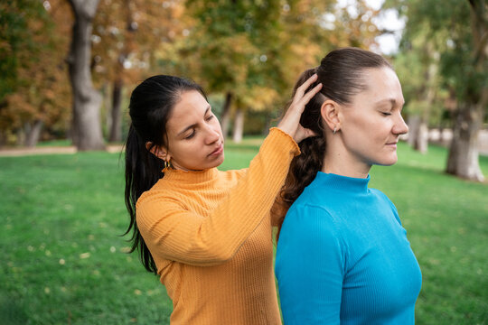 Women practicing energy healing in a peaceful park retreat