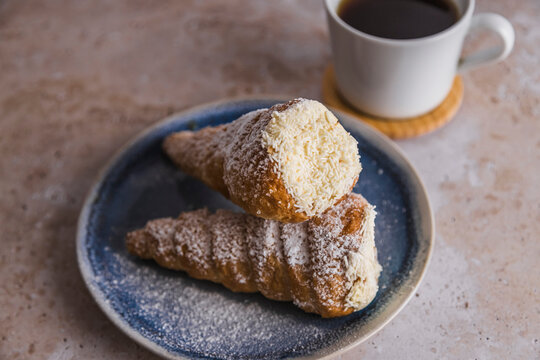 Conic cannoli Italian pastry with cream and coffee