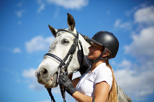 Woman enjoying a moment with her horse outdoors