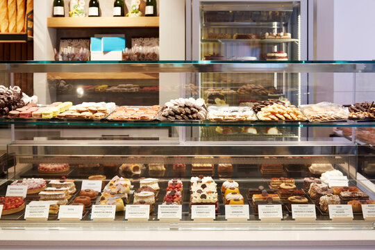 Bakery display case with assorted pastries and cakes