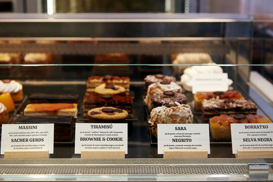 Assorted pastry and cake in bakery display case with label