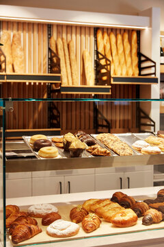 Fresh pastry and bread display in modern bakery shop