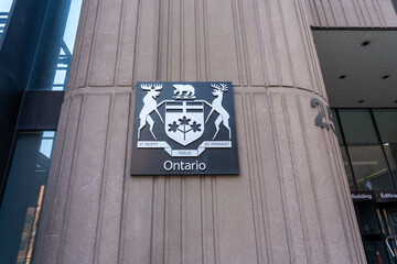 Fototapeta premium Toronto, Ontario, Canada - May 18, 2026: A coat of arms of Ontario on the building in Toronto, Ontario, Canada. The coat of arms of Ontario is the armorial emblem representing the Canadian province of