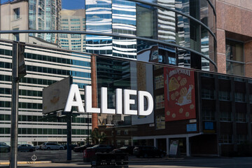 Fototapeta premium Toronto, Canada - May 18, 2026: A closeup signage for Allied at an office building in Toronto, Canada. Allied Properties REIT is a leading owner and developer of urban office space that enhances profi