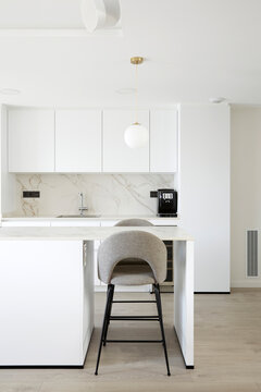 Minimal white kitchen with island and bar stool interior