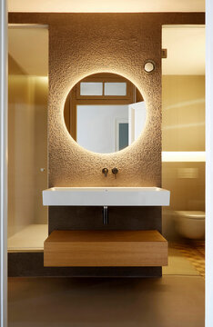 Modern bathroom vanity with round backlit mirror design