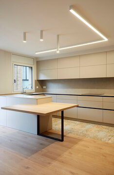 Modern minimalist kitchen interior with island and LED light