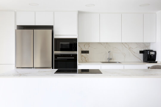 Minimal white kitchen interior with modern appliance