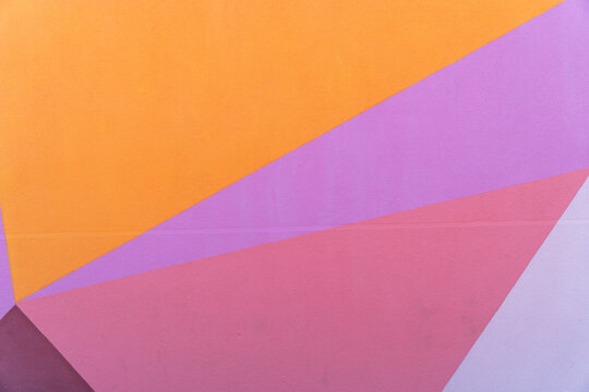 Colorful geometric wall with pastel triangles and bold shapes