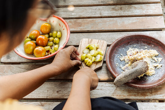 Preparing traditional Indonesian fruit and spice paste at home