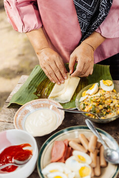 Preparing traditional Indonesian street food on banana leaf