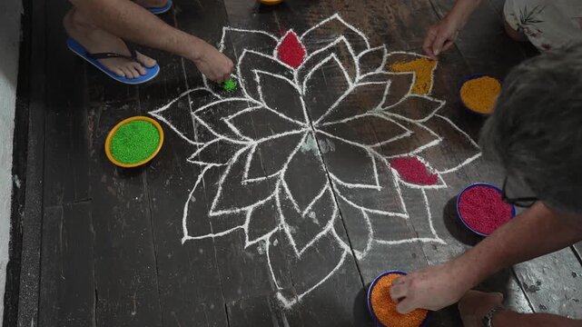 View of tourists performing the Hindu family art of Kolam, drawings made of coloured rice, Nuwara Eliya, Central Province, Sri Lanka, Asia