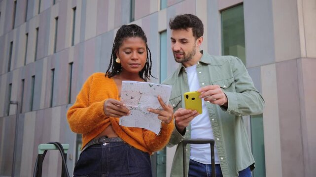 Engaged travelers analyzing a map closely while discovering an unfamiliar location full of adventures.