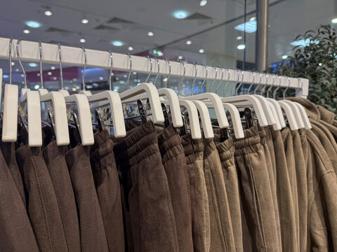 Clothing hanger row with set of pants in store display
