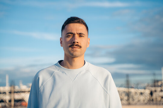 Man portrait outdoors in Lisbon with blue sky background