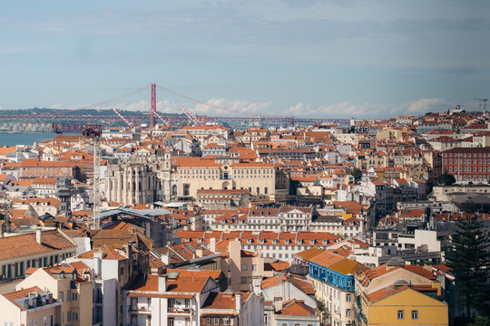 Lisbon cityscape with red roofs and 25 de Abril Bridge