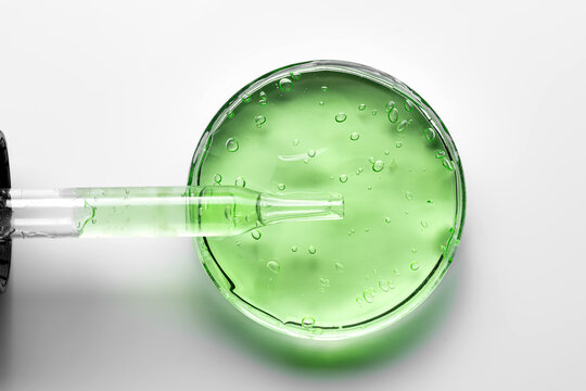 Green gel texture in cosmetics dish with dropper
