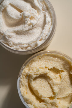 Close-up body scrub texture in jars with creamy smear