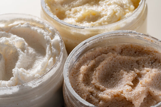 Close-up body scrub texture smears in cosmetic jars
