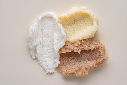 Body scrub smear texture with exfoliating grains on beige