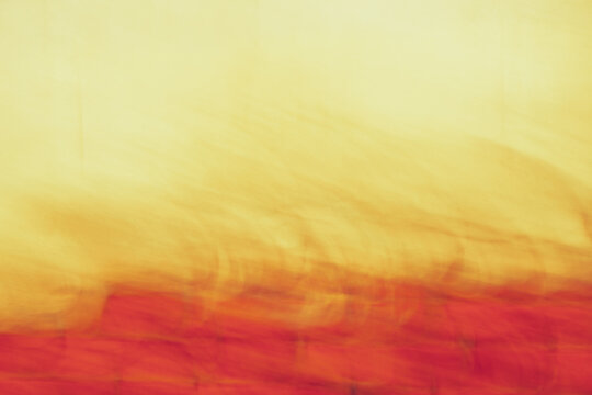 Abstract warm gradient motion blur background in red yellow