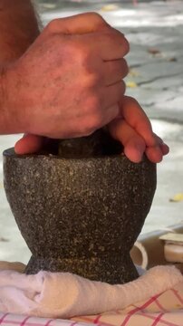 Closeup of Hands with a Mortar and Pestle 
