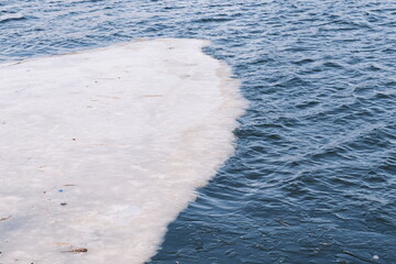 Floating glacier ice in a cold river landscape. © marinatea