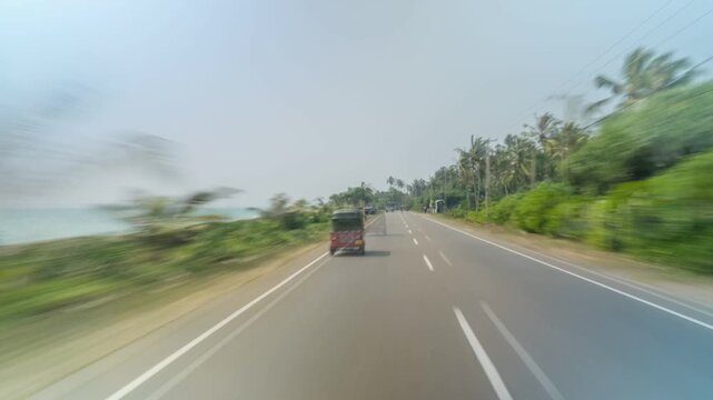 Time lapse from moving vehicle of traffic in road near Galle, Southern Province, Sri Lanka, Asia