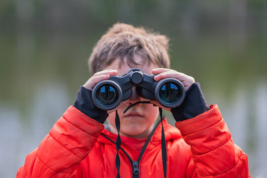 Child enjoying birdwatching adventure in nature