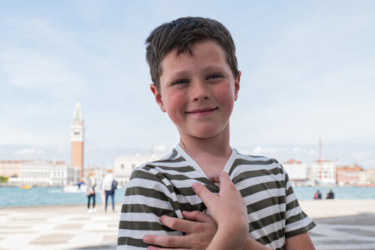 Smiling child portrait by the Venice lagoon on a sunny day