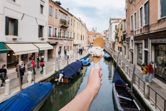 Gelato in hand above a quiet canal street in Venice