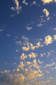 Golden scattered cloud in deep blue sky at sunset