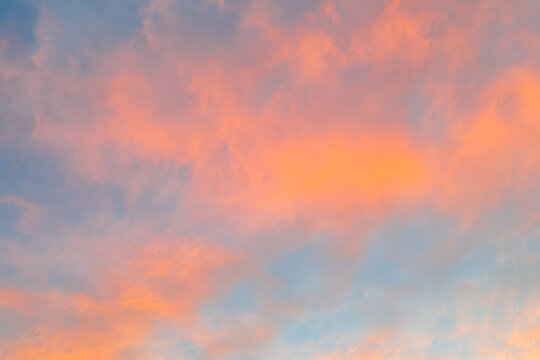 Pastel sunset sky with soft clouds and warm glow