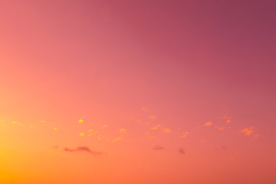 Pastel sunset sky gradient with soft cloud and copy space
