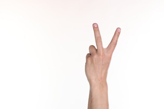 Man showing number two with fingers on white background, closeup. Space for text