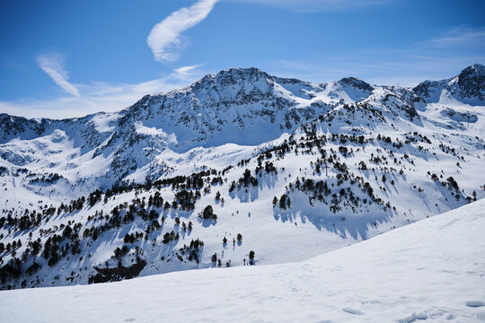 Snowy mountain landscape in Andorra under clear blue sky