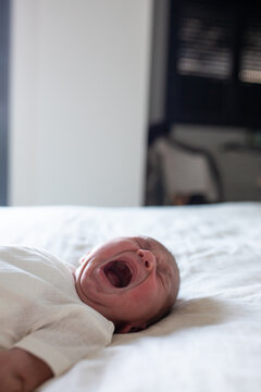 Newborn baby softly crying in serene setting