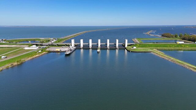 Cargo ship passing through the haringvlietdam sluices in the netherlands
