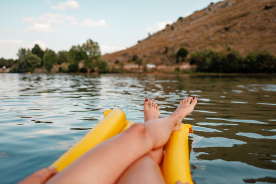 Relaxing summer day on a lake on a yellow inflatable