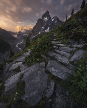 Mountainous landscape at sunset with rocky path