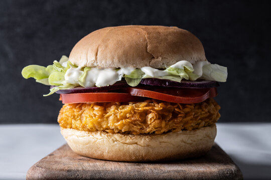 Crispy fried chicken burger with lettuce and tomato