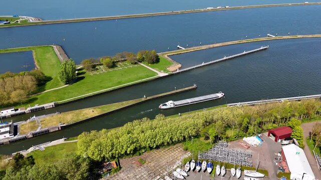 Aerial view of a large inland tanker ship sailing through a canal system
