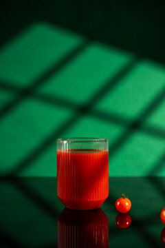 Fresh tomato juice in dramatic dark ambiance