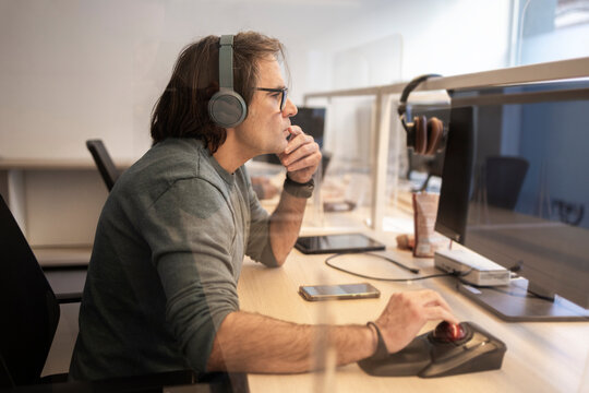Focused coworker working at computer in modern office